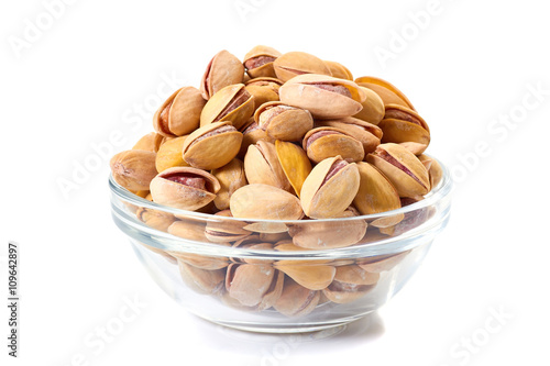 Heap of pistachios nuts in glass bowl