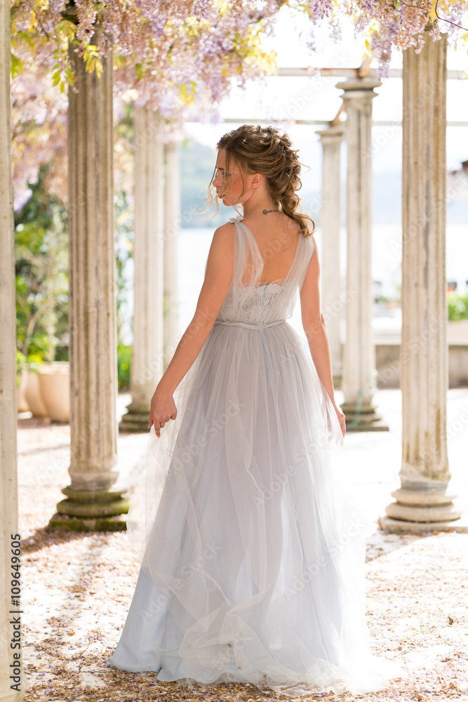 young bride in a wedding dress poses on the terrace young bride in a wedding dress poses on the terrace