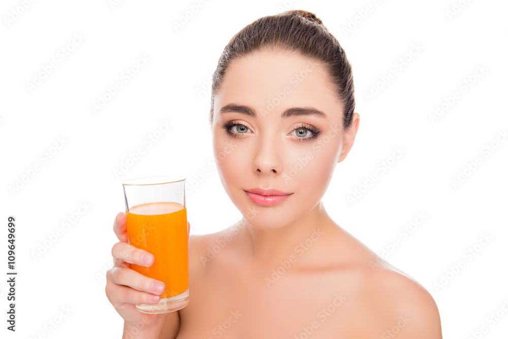 Pretty smiling young girl holding glass with orange juice Pretty smiling young girl holding glass with orange juice