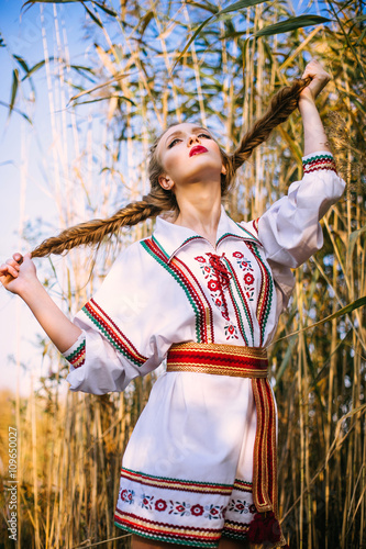 Young girl on the summer field in national Belarus clothes, fas