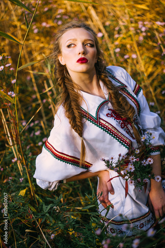 Young girl on the summer field  in national Belarus clothes, fas