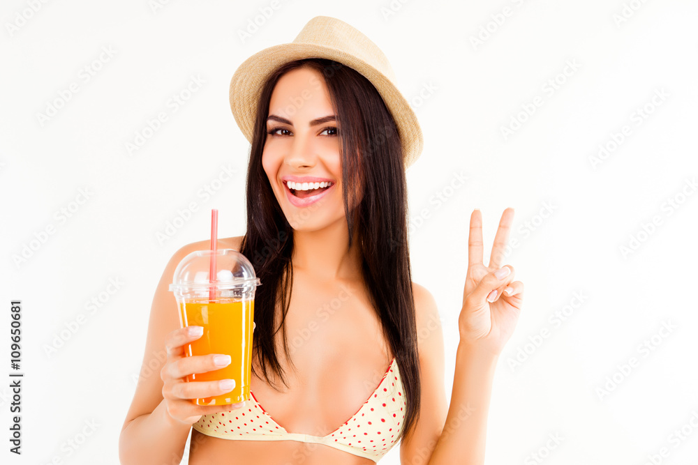 Happy woman in bikini and hat holding cocktail and gesturing wit Happy woman in bikini and hat holding cocktail and gesturing wit