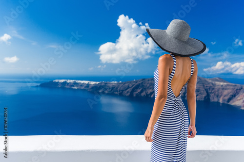 Фотография Luxury travel vacation woman looking at view on Santorini famous Europe travel destination