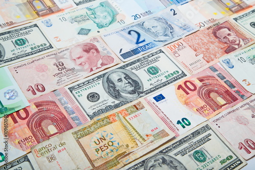 Background from paper money of the different countries. American dollars in the middle