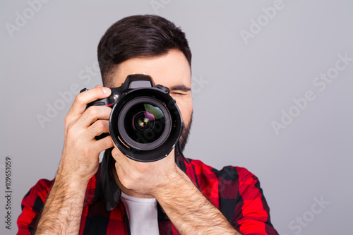 Portrait of professional photographer with digital camera takin
