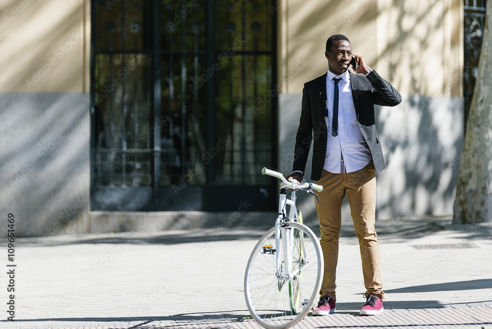 African man with mobile phone and bicycle. African man with mobile phone and bicycle.