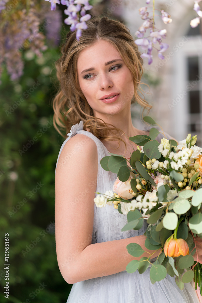 Young bride portrait with a wedding bouquet