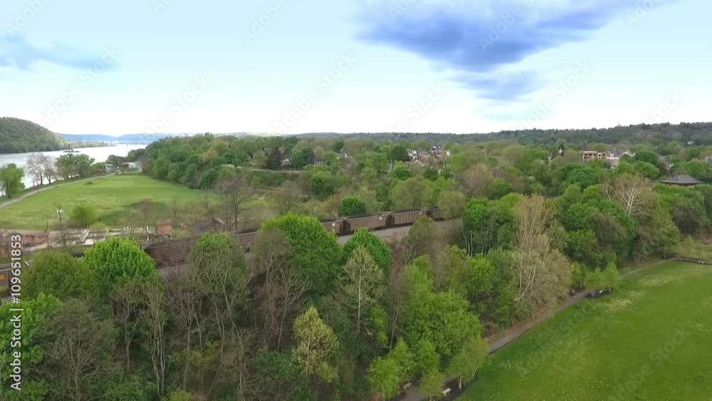 An aerial establishing shot of a coal train cutting through the hillsides of Western Pennsylvania. An aerial establishing shot of a coal train cutting through the hillsides of Western Pennsylvania.