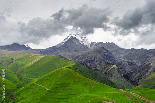 Trekking in Caucasus Mountains (Georgia) - view of the Mount Kazbek covered with clouds