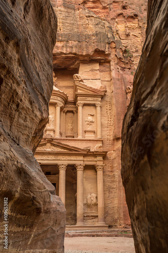 Hiking through the canyon in the ancient city of Petra (Jordan) - opening view of the famous Al-Khazneh (aka Treasury)