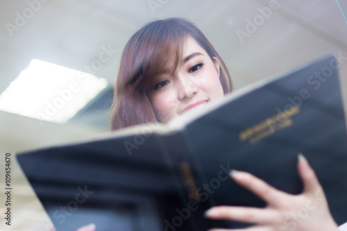 young beautiful asian girl student in library