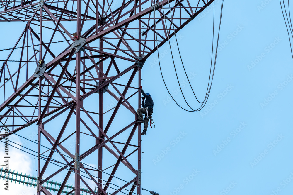 Tthe worker climbing on the high dangerous powerlines