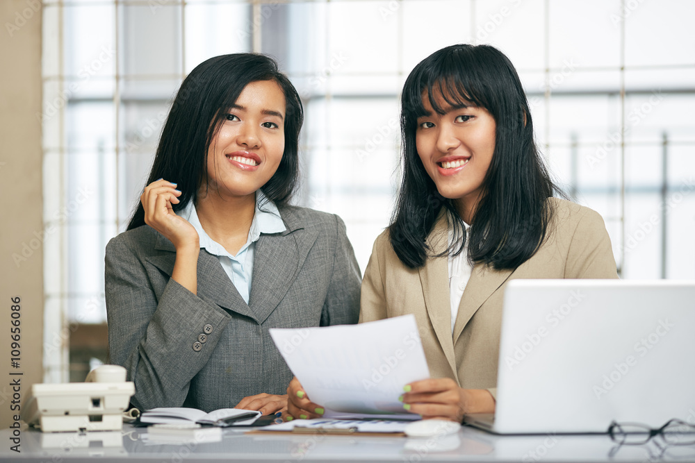 close up image of two businesswomen working and discussing in office
close up image of two businesswomen working and discussing in office