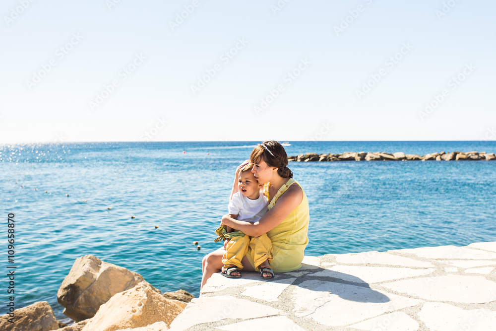 mother and son playing on the beach