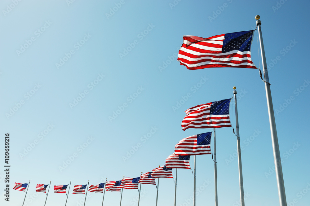 Fototapeta premium USA flags in a row waving in the wind