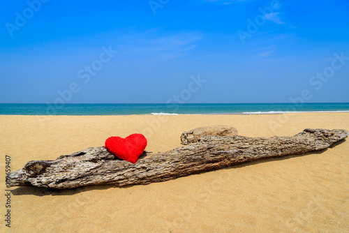 Fototapeta Naklejka Na Ścianę i Meble -  Close up red hearts on ocean beach sand - love concept for holiday.