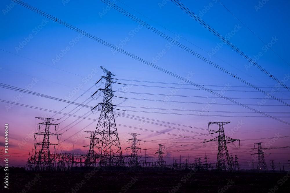 The silhouette of the evening electricity transmission pylon