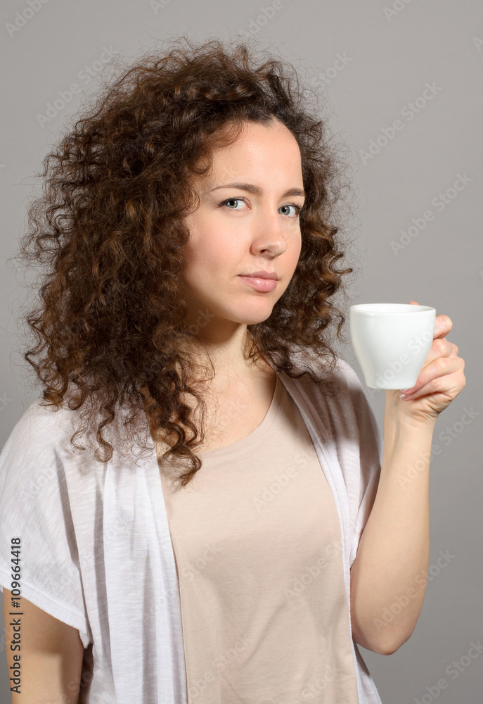 Business woman coffee cup hold over grey background Business woman coffee cup hold over grey background