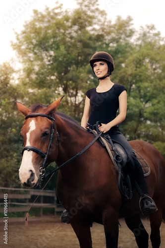 Happy Horsewoman Ridding in a Manege