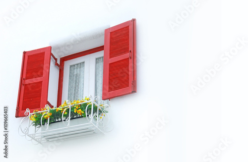 outer opened red and white inner closed window with white wall decorated with flowerpod photo