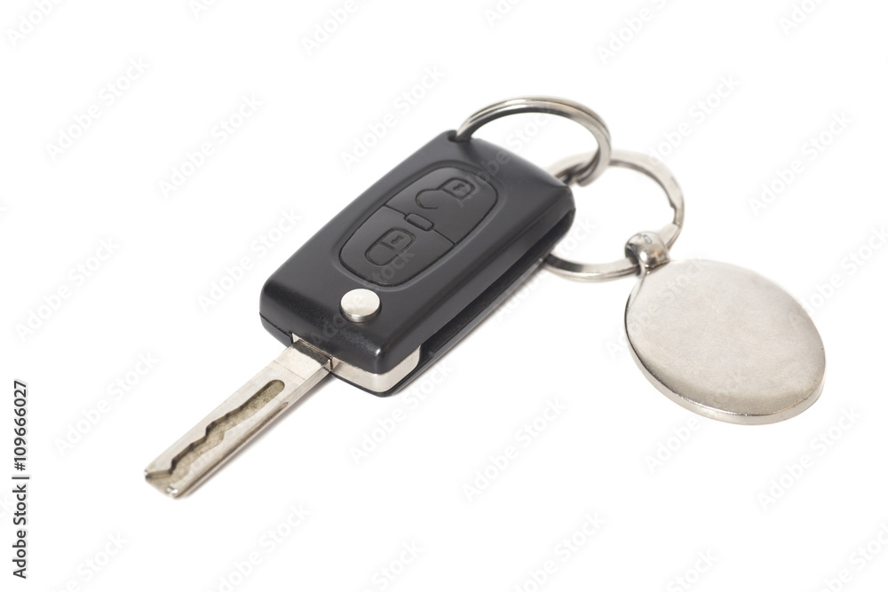 Remote control car key with metal keyring on isolated white back Remote control car key with metal keyring on isolated white back