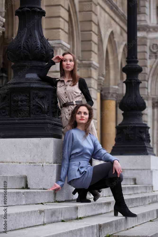 Two beautiful young women in front of classical Viennese architecture Two beautiful young women in front of classical Viennese architecture