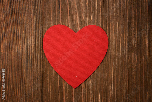 red heart on wooden background