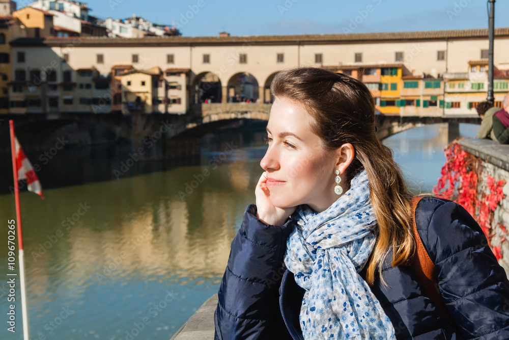 Young girl enjoying the view of Ponte Vecchio in Florence, Tuscany, Italy