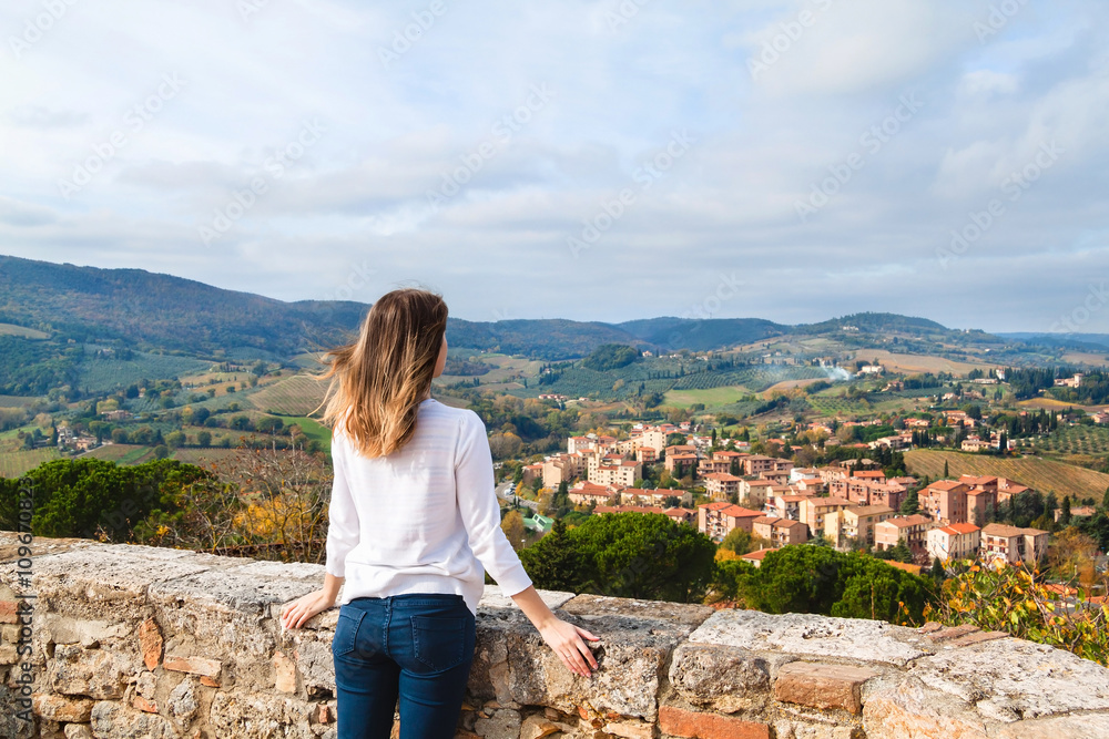 Young girl enjoying the view from San Gimignano, Tuscany, Italy