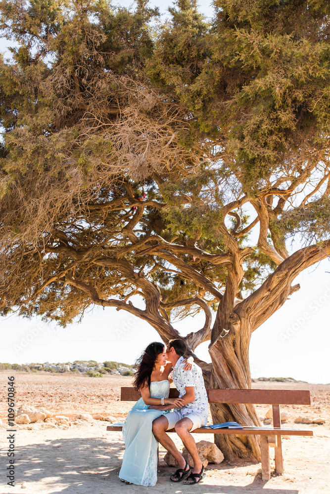 Cute couple kissing outdoors on a sunny day Cute couple kissing outdoors on a sunny day
