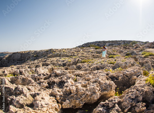 beautiful couple embrace on a stones