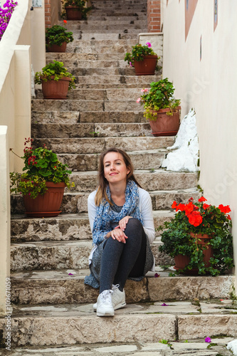 Girl sitting on a steps in Sperlonga, Italy photo