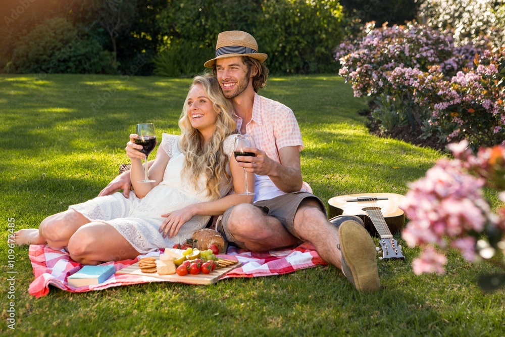 Happy couple having a picnic and embracing Happy couple having a picnic and embracing