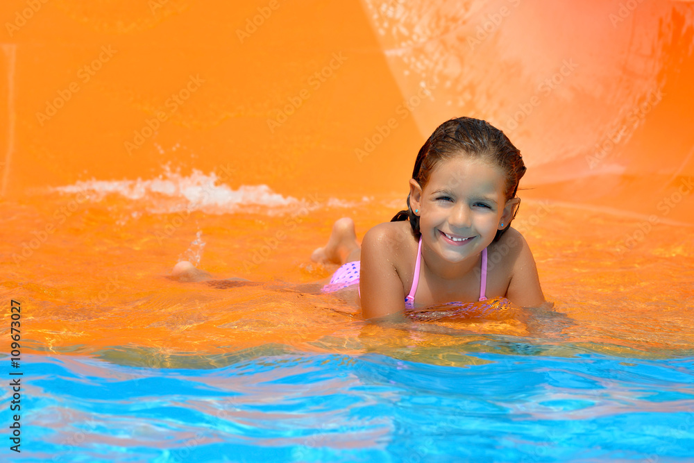 Adorable toddler girl enjoying her summer vacation at aquapark Adorable toddler girl enjoying her summer vacation at aquapark