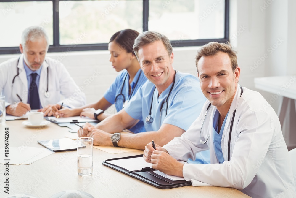 Portrait of doctors smiling in conference room Portrait of doctors smiling in conference room