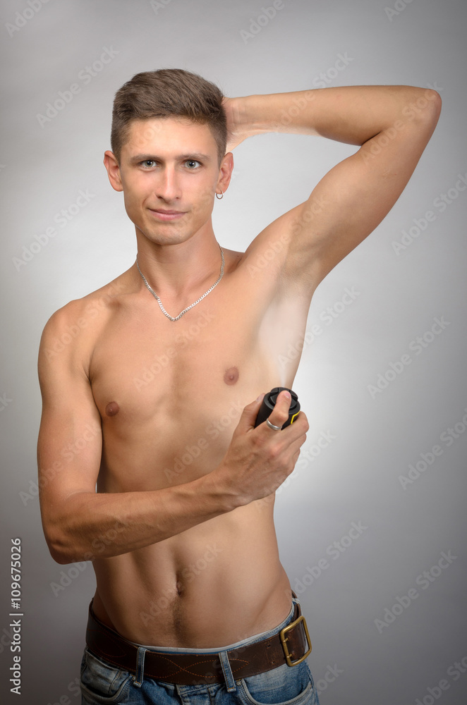 Photo of handsome man using deodorant,Man using deodorant Photo of handsome man using deodorant,Man using deodorant