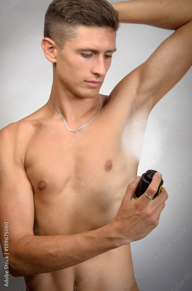 Photo of handsome man using deodorant,Man using deodorant Photo of handsome man using deodorant,Man using deodorant
