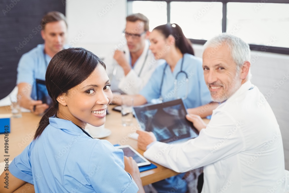Portrait of doctors smiling in conference room Portrait of doctors smiling in conference room