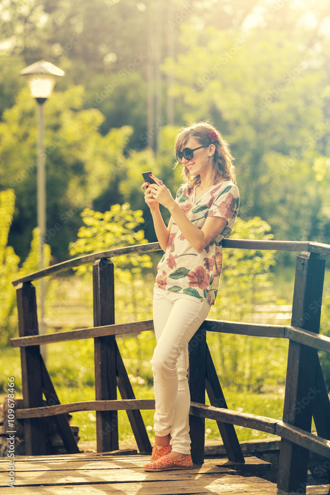 Girl using smartphone outdoors.
