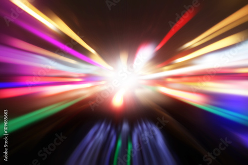 Motion blurred image of car driving fast at night.