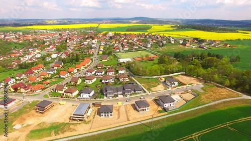 Camera flight over small village Litice suburb of Pilsen. Living in agricultural landscape. Environmentally friendly living. Czech Republic, Europe.  photo