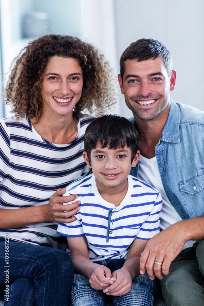 Portrait of happy family sitting together on sofa Portrait of happy family sitting together on sofa