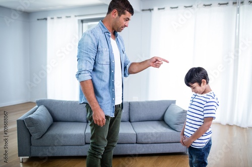 Fotografie Angry father scolding his son