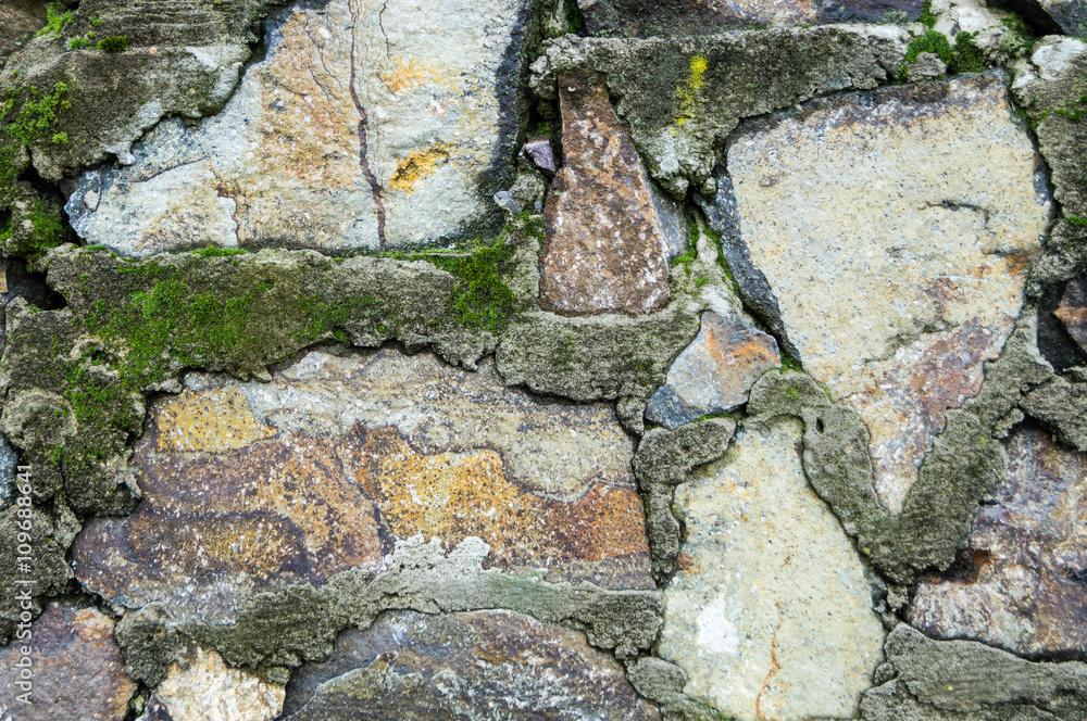 Natural brick stone wall sprinkles of moss and crystalline struc