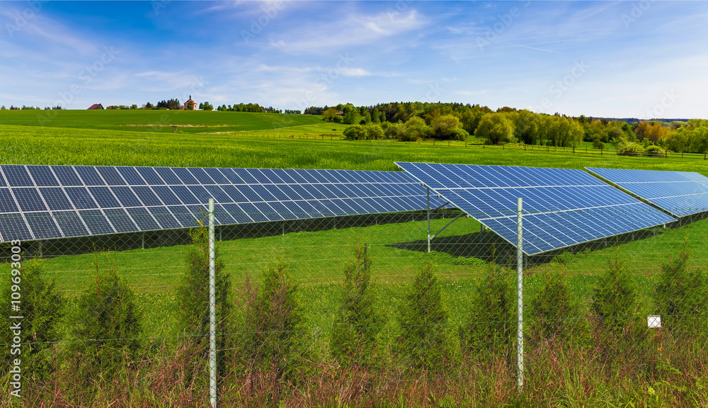 Solar energy panels on green field, blue sky Solar energy panels on green field, blue sky