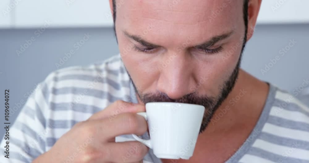 Handsome man using tablet while drinking coffee Handsome man using tablet while drinking coffee