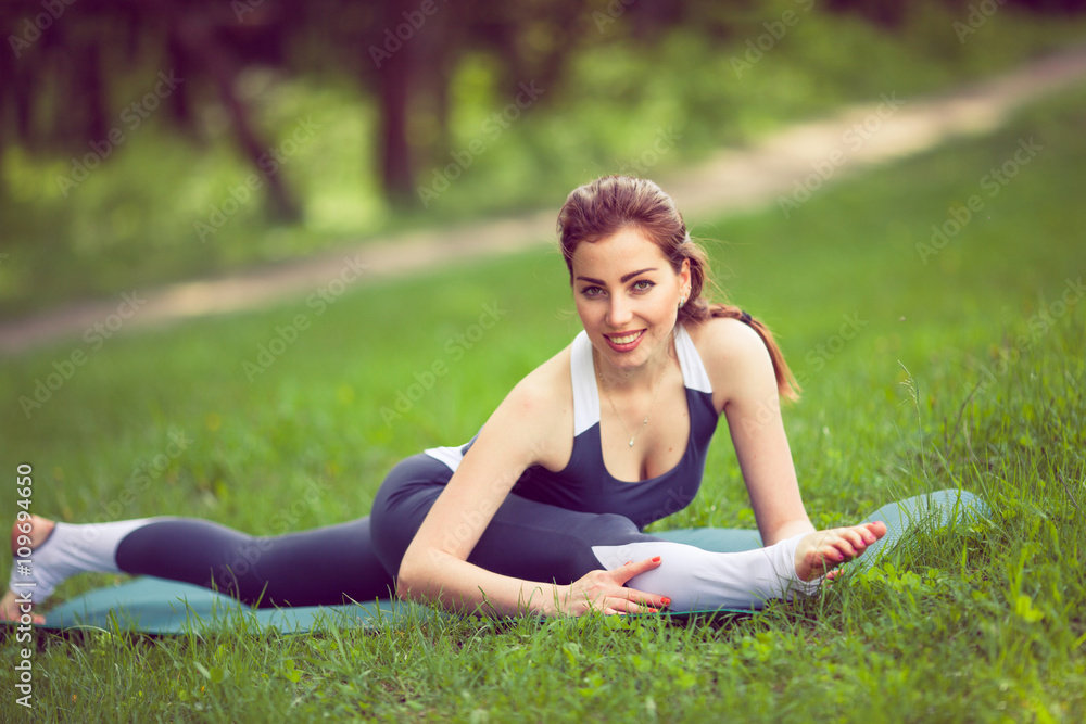 Young woman doing yoga in morning park. Young woman doing yoga in morning park.