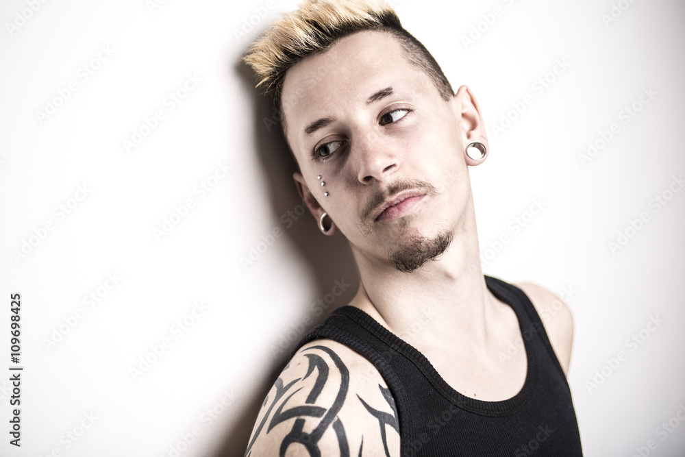 Handsome stylish young man with tattoo and piercing Handsome stylish young man with tattoo and piercing