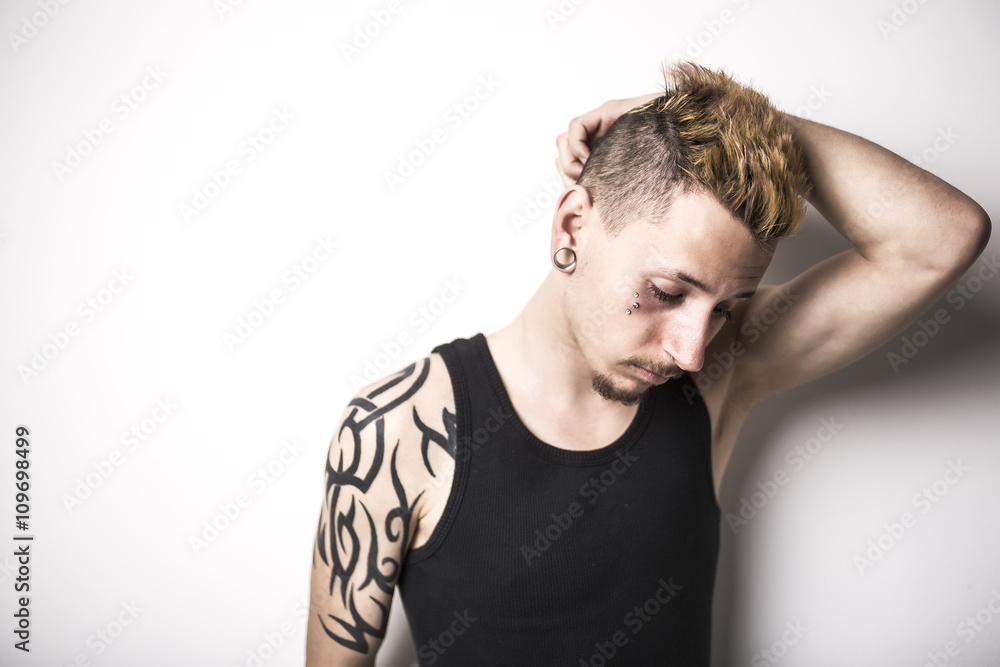 Handsome stylish young man with tattoo and piercing Handsome stylish young man with tattoo and piercing