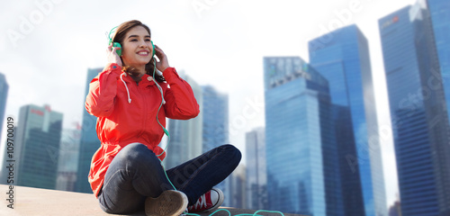 Canvas Print happy young woman in headphones listening to music